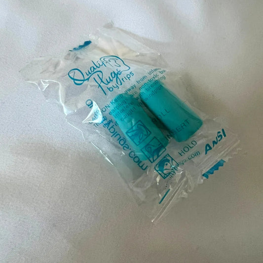 A pair of individually wrapped earplugs in a clear plastic packaging.
