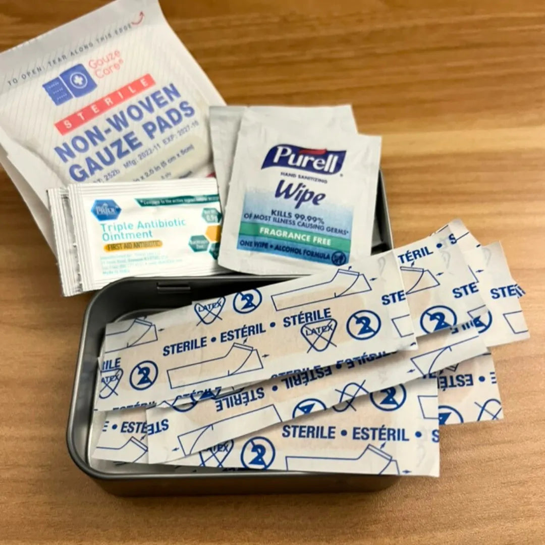Altoid size tin first aid kit with purell wipes, guaze, bandages, and antibiotic ointment cream