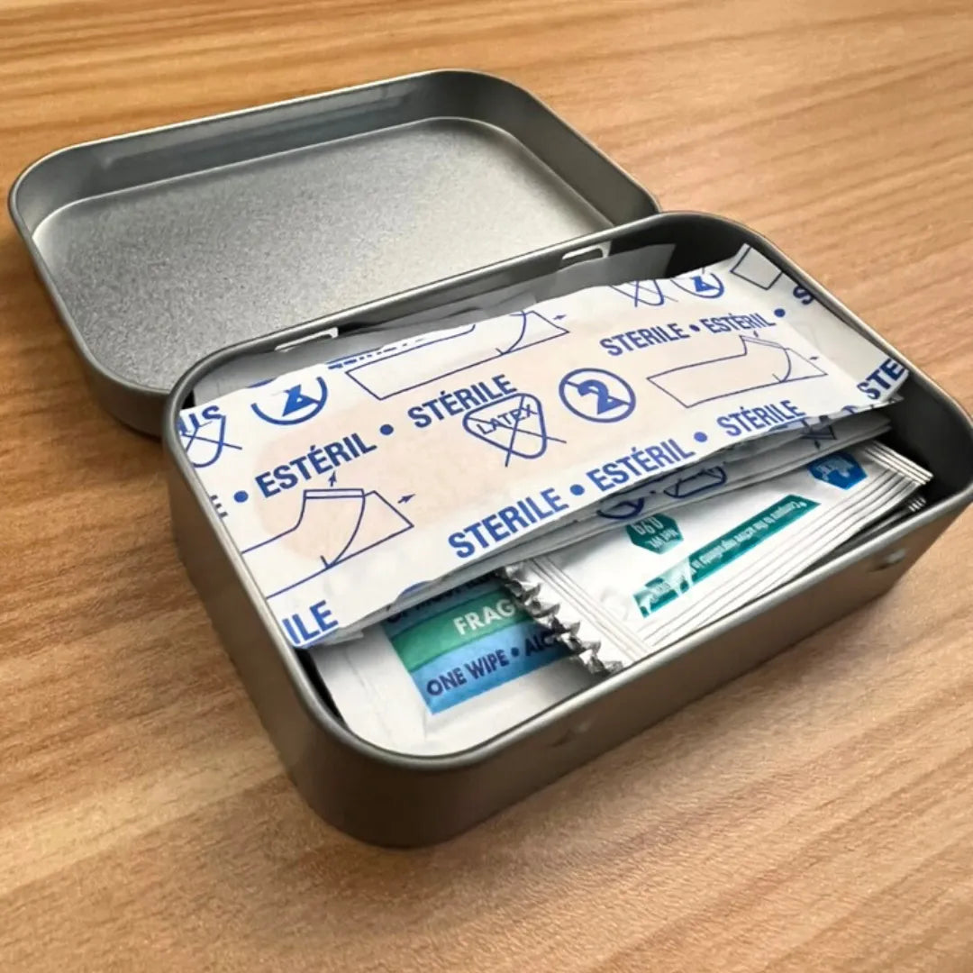 altoid size first aid kit with bandages, alcohol wipes, antibiotic cream
