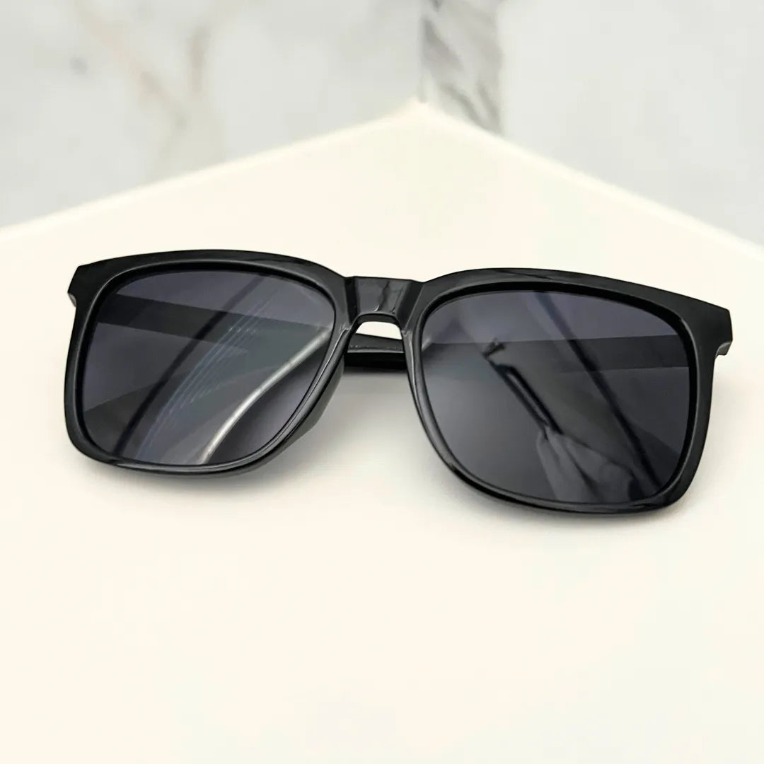 classic flat frame sunglasses on a countertop